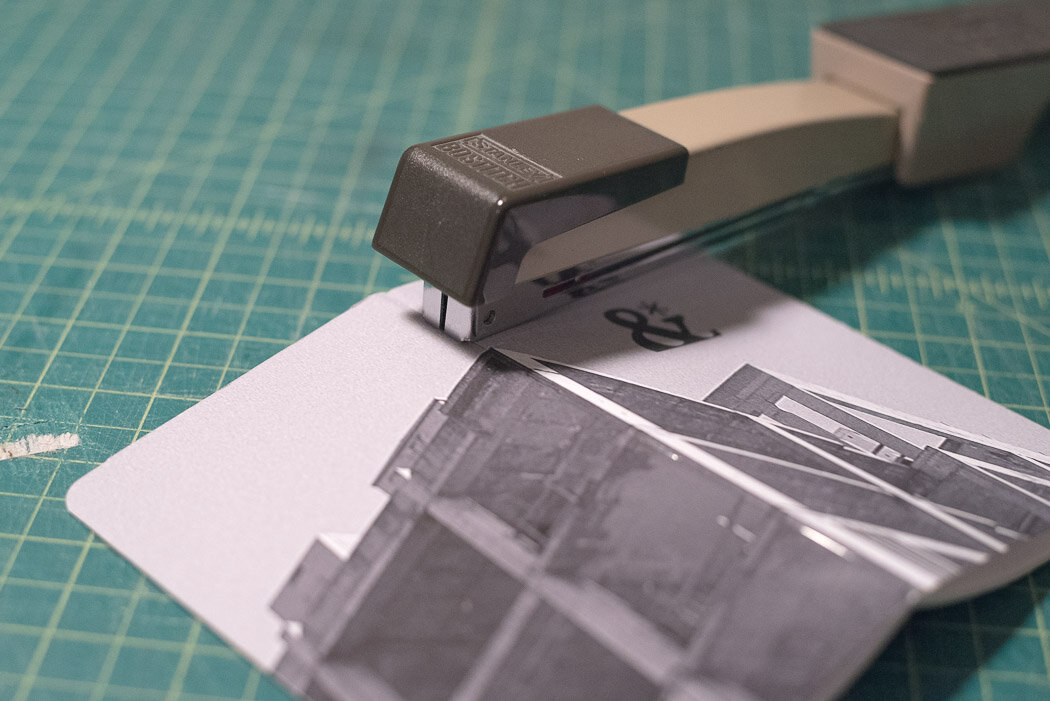process photo showing the stapler on the spine of the cover