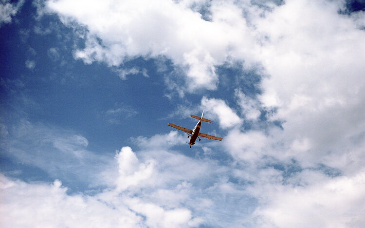 small plane in the sky from below