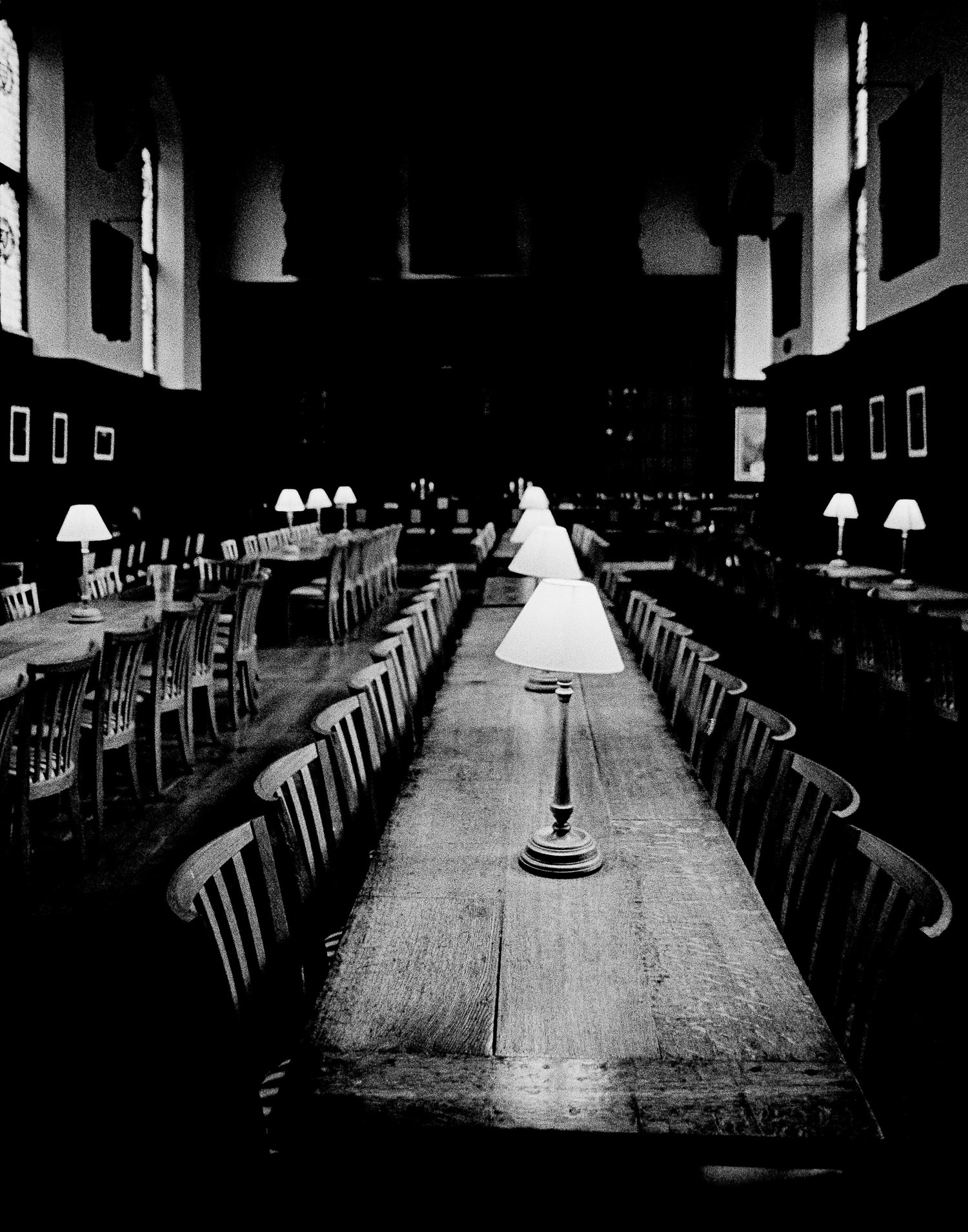 Long wooden table with lamps and wooden chairs at Magdalen College, Oxford